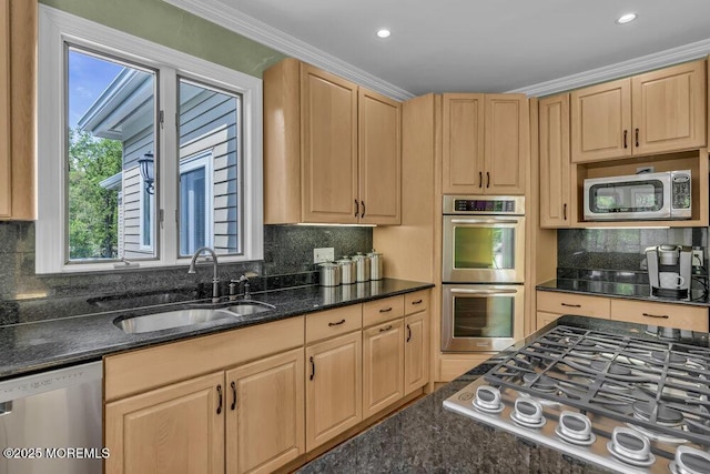 kitchen featuring a sink, light brown cabinetry, and stainless steel appliances