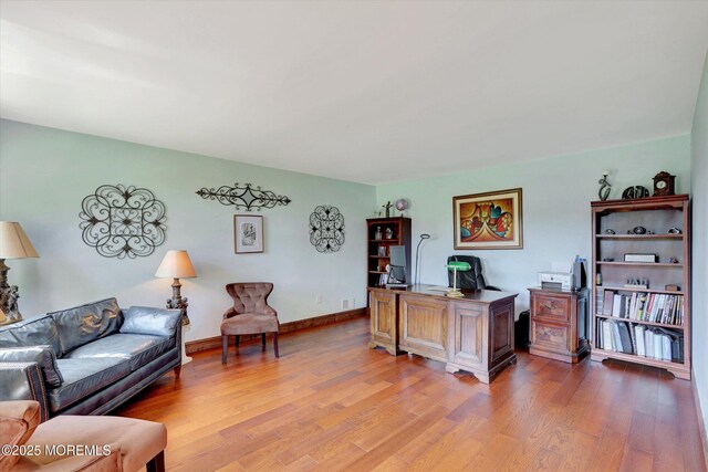 office space with light wood-style floors and baseboards