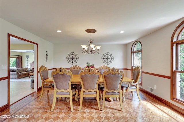 dining area featuring a chandelier, baseboards, and recessed lighting