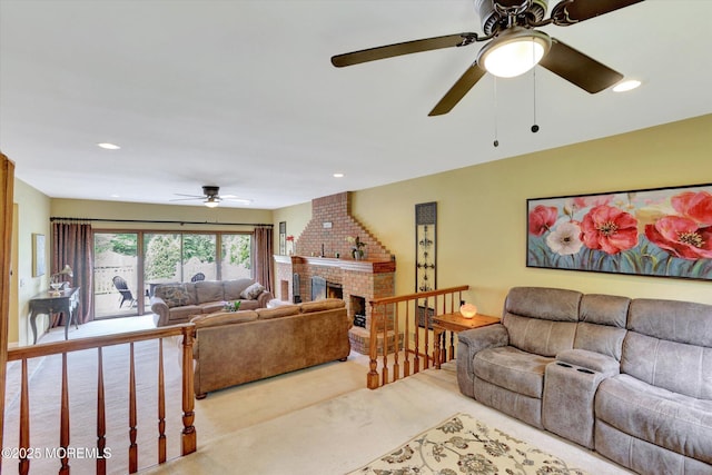 living area featuring ceiling fan, carpet flooring, a brick fireplace, and recessed lighting