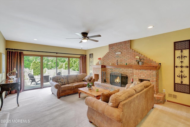 living area with light carpet, ceiling fan, a fireplace, and recessed lighting