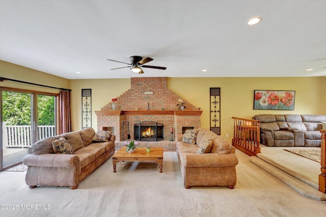 living area with a ceiling fan, carpet, a fireplace, and recessed lighting