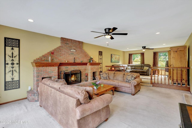 living area with light carpet, ceiling fan, a brick fireplace, recessed lighting, and baseboards