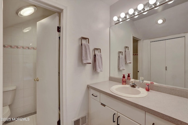 full bathroom with toilet and vanity
