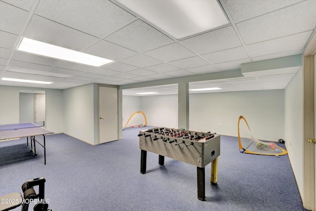 game room featuring a paneled ceiling and carpet