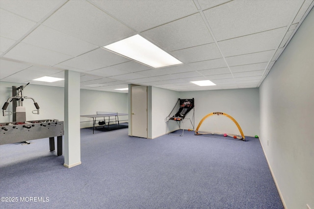 recreation room featuring carpet flooring, a paneled ceiling, and baseboards