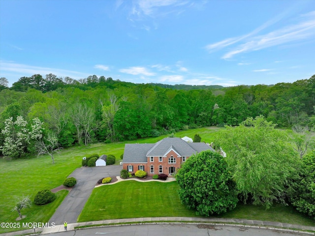 view from above of property featuring a heavily wooded area