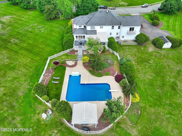 aerial view of property and surrounding area featuring a pool area