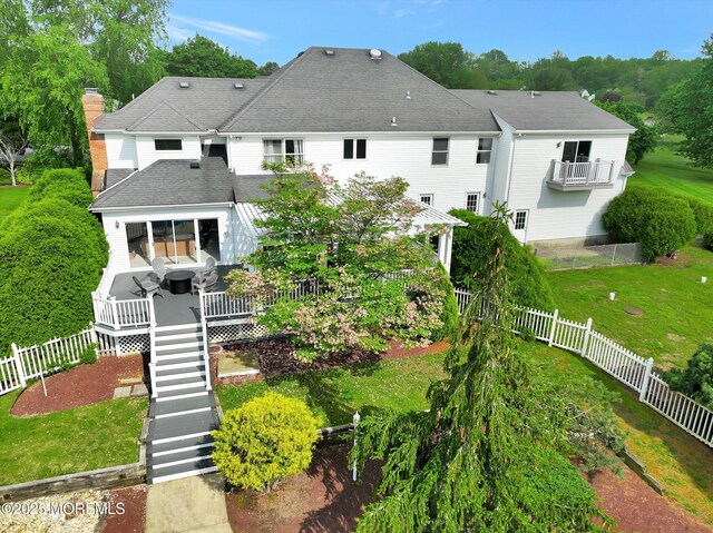 rear view of property featuring a deck, a chimney, and stairway