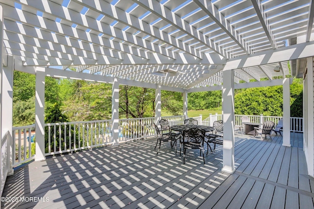 wooden terrace with outdoor dining area and a pergola