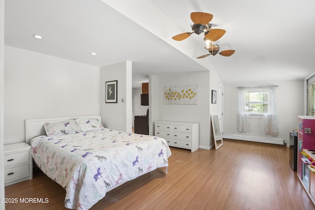 bedroom with wood finished floors, baseboards, ceiling fan, recessed lighting, and a baseboard radiator