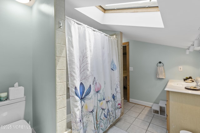 bathroom featuring curtained shower, tile patterned flooring, a skylight, and toilet