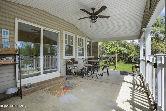 view of patio / terrace with covered porch, outdoor dining area, and ceiling fan