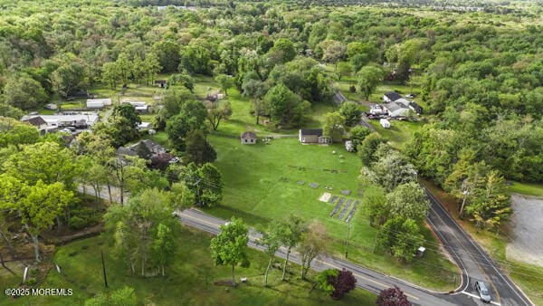 aerial overview of property's location with a heavily wooded area
