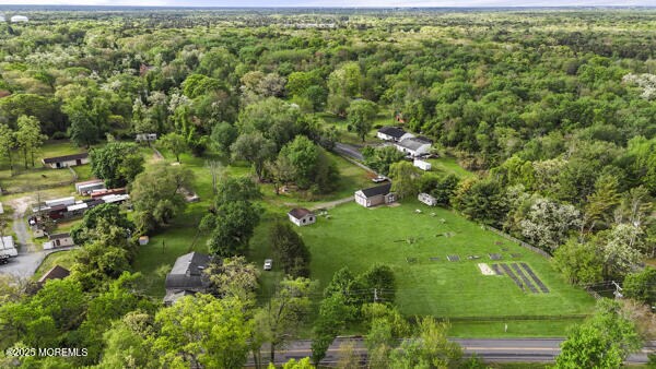 aerial view of property's location with a forest