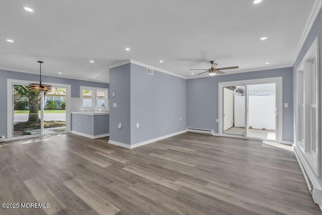 829A Westminster Ct, Manchester, NJ 08759 - unfurnished living room with crown molding, a baseboard radiator, wood finished floors, and visible vents