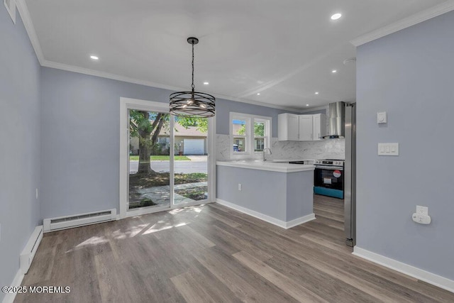 829A Westminster Ct, Manchester, NJ 08759 - kitchen with crown molding, baseboard heating, light countertops, wall chimney exhaust hood, and a baseboard heating unit