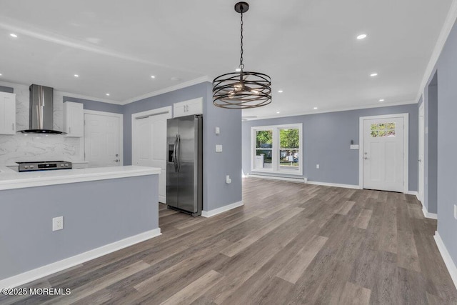 829A Westminster Ct, Manchester, NJ 08759 - kitchen with wall chimney range hood, white cabinetry, appliances with stainless steel finishes, and ornamental molding