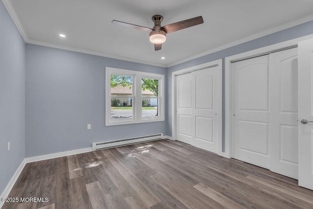 829A Westminster Ct, Manchester, NJ 08759 - unfurnished bedroom featuring multiple closets, baseboards, wood finished floors, a baseboard radiator, and ornamental molding