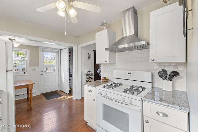 39-43 Twilight Ave, Keansburg, NJ 07734 - kitchen featuring wall chimney range hood, backsplash, white cabinets, white range with gas cooktop, and dark wood-type flooring
