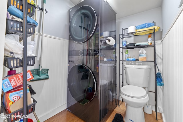 39-43 Twilight Ave, Keansburg, NJ 07734 - bathroom featuring stacked washer and dryer, toilet, wainscoting, and wood finished floors