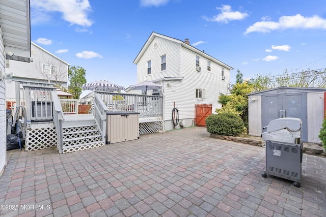 39-43 Twilight Ave, Keansburg, NJ 07734 - view of patio / terrace with a storage unit, an outbuilding, and a deck