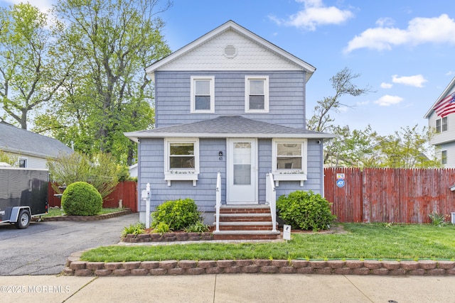 39-43 Twilight Ave, Keansburg, NJ 07734 - view of front of property featuring roof with shingles, fence, entry steps, and a front lawn