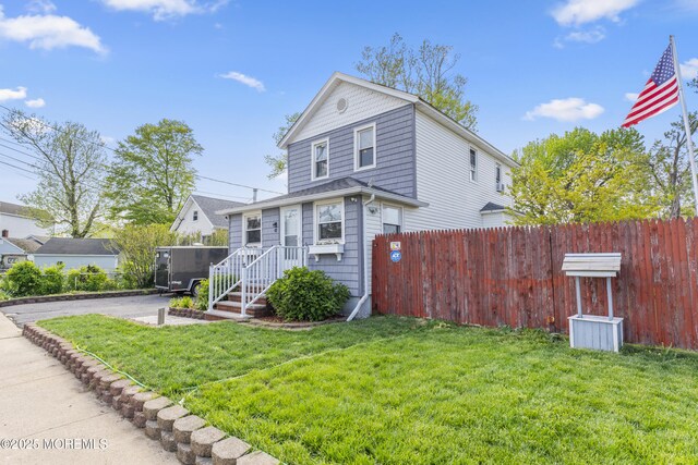 39-43 Twilight Ave, Keansburg, NJ 07734 - view of front of house featuring fence and a front lawn
