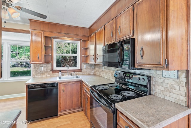 kitchen with black appliances, a sink, open shelves, brown cabinets, and crown molding