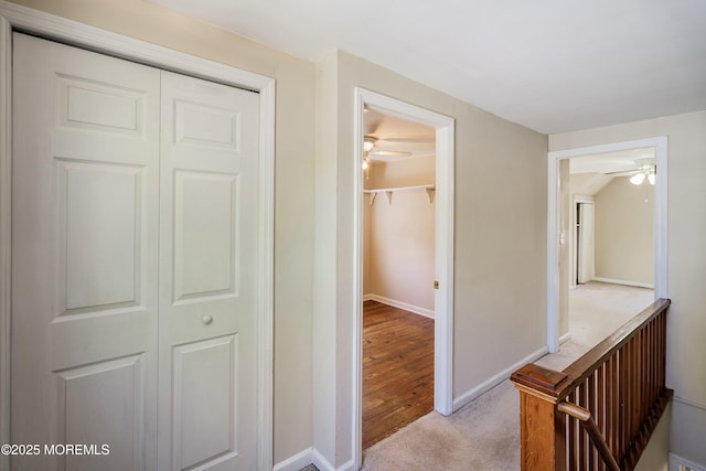 corridor with light carpet and baseboards