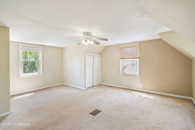 bonus room featuring a ceiling fan, carpet, lofted ceiling, and baseboards