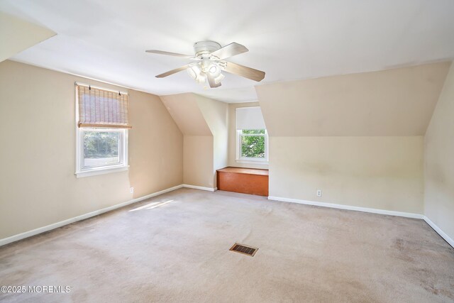 bonus room featuring lofted ceiling, a ceiling fan, baseboards, and carpet floors