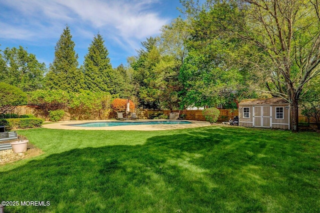 view of yard with an outdoor structure, a fenced in pool, a fenced backyard, and a storage unit