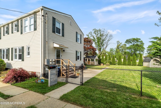 rear view of house with a gate and an outdoor structure