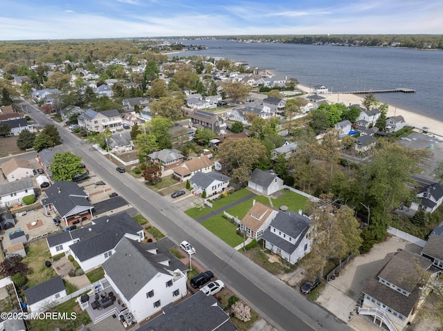 drone / aerial view featuring a residential view and a water view