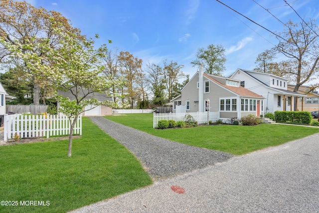view of property exterior featuring a lawn and a fenced front yard