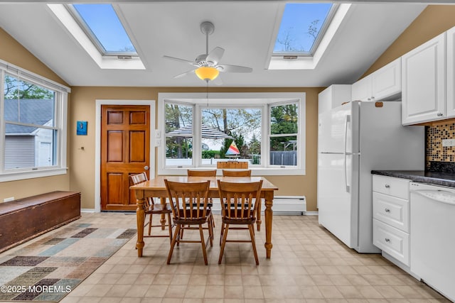 dining space with a ceiling fan, light floors, lofted ceiling with skylight, and a baseboard radiator
