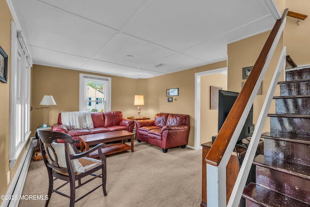 living area featuring carpet, a baseboard heating unit, and stairs