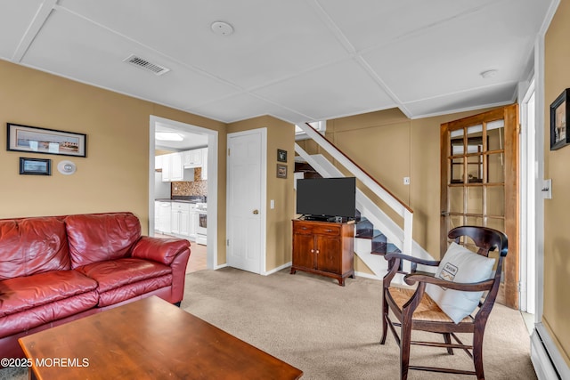 living room with visible vents, baseboard heating, stairway, baseboards, and light carpet