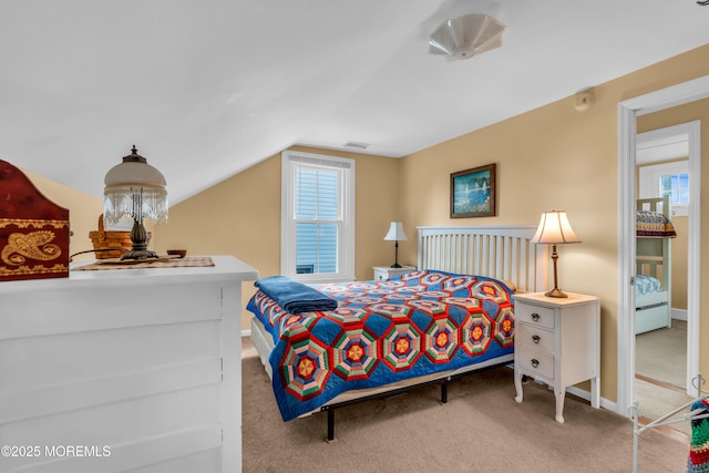 bedroom with baseboards, carpet, vaulted ceiling, and visible vents