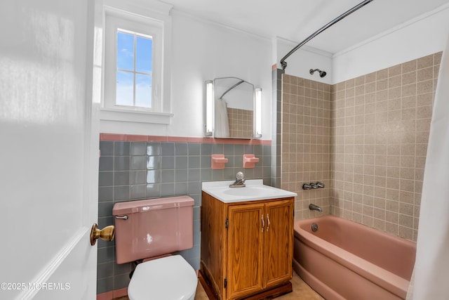 bathroom with shower / bathing tub combination, crown molding, tile walls, vanity, and toilet