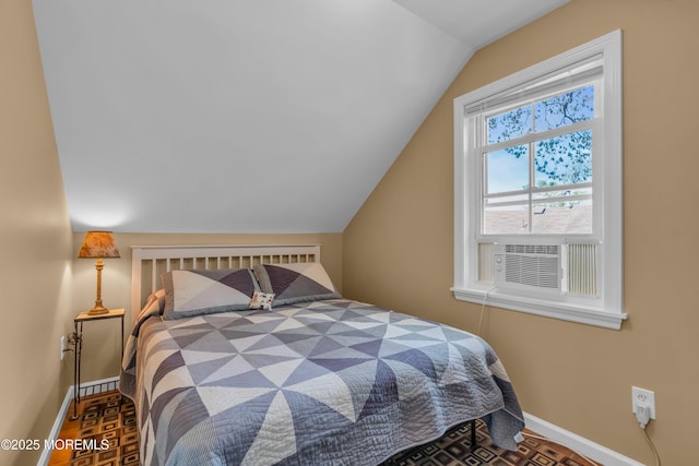 bedroom with baseboards, lofted ceiling, and cooling unit