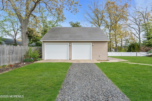 detached garage featuring fence