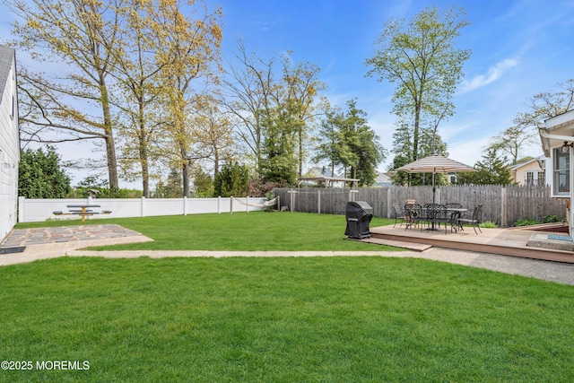 view of yard with a fenced backyard and a wooden deck