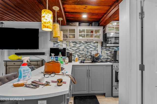 kitchen with wooden ceiling, appliances with stainless steel finishes, gray cabinets, and a sink