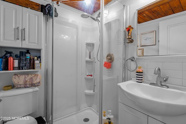full bath with vanity, toilet, a shower stall, and backsplash
