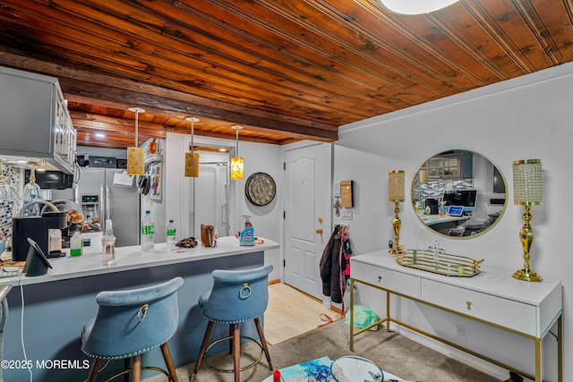 kitchen with a peninsula, a kitchen breakfast bar, light carpet, wood ceiling, and stainless steel fridge with ice dispenser