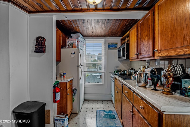 kitchen featuring wood ceiling, brown cabinets, light floors, white appliances, and light countertops