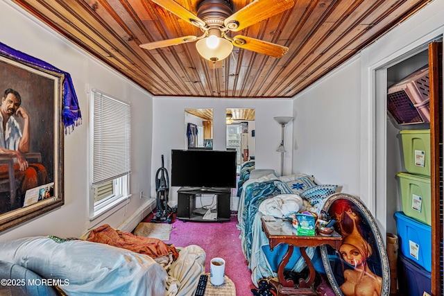 carpeted bedroom featuring a ceiling fan, crown molding, and wood ceiling