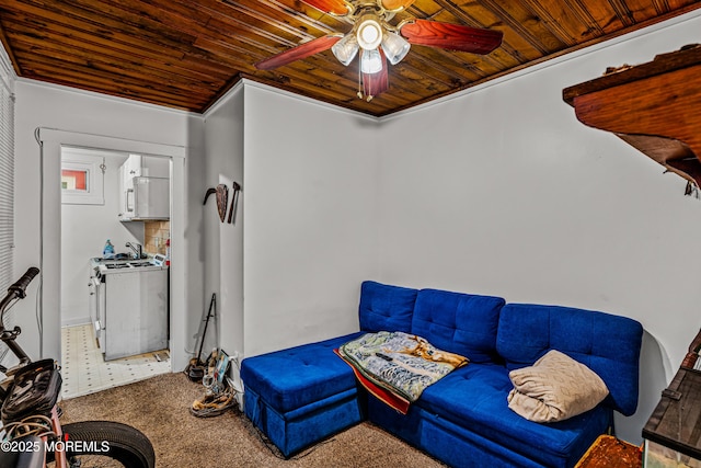 sitting room featuring crown molding, wood ceiling, a ceiling fan, and carpet flooring